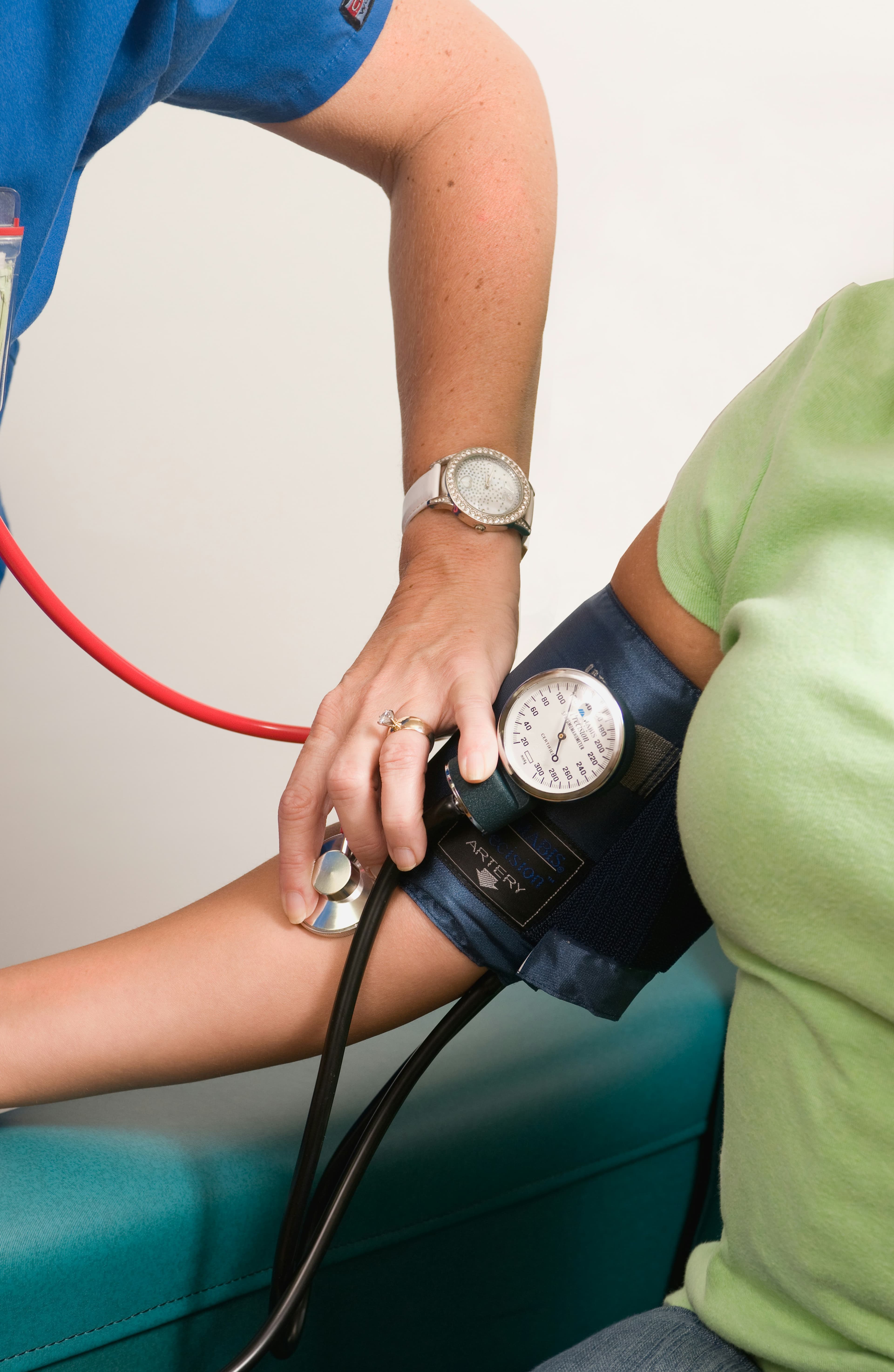 A BrevCare caregiver checking a client's blood pressure at home